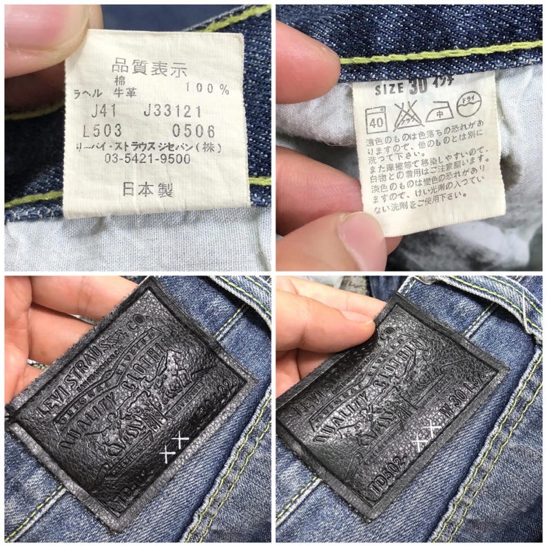May include: Close-up of a pair of blue denim jeans with a leather patch that reads "Levi Strauss & Co. Quality Clothing" and a white tag with Japanese text and the size "30" in inches.