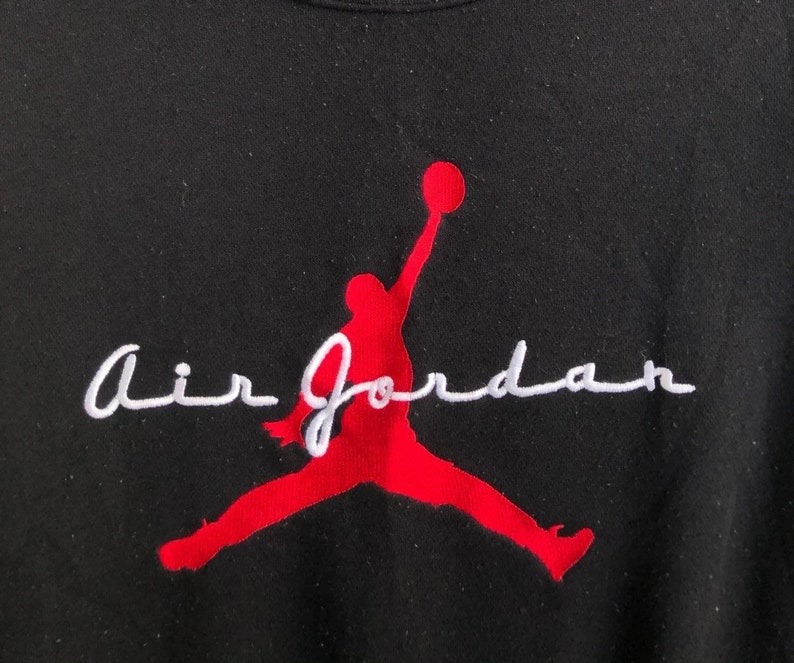 May include: Black sweatshirt with a red silhouette of a basketball player jumping and the text "Air Jordan" in white cursive.