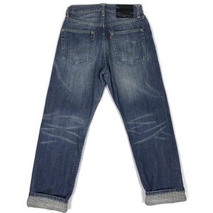 May include: A pair of blue denim jeans with a cuffed hem. The jeans have a faded look and are distressed in places.
