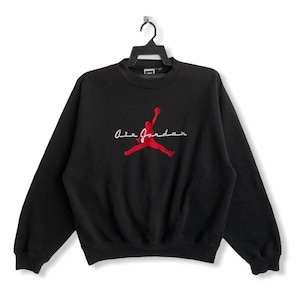 May include: Black sweatshirt with a red embroidered Air Jordan logo and the text "Air Jordan" in white.