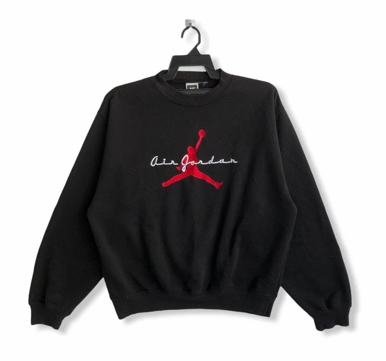 May include: Black sweatshirt with a red embroidered Air Jordan logo and the text "Air Jordan" in white.