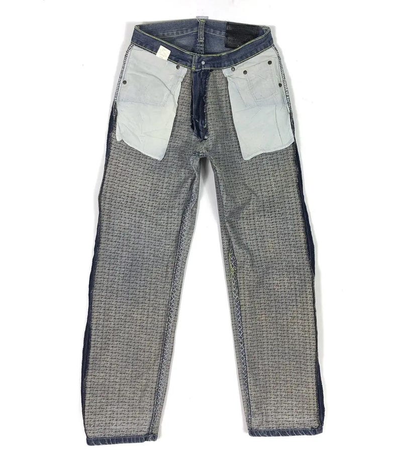 May include: A pair of blue denim jeans with a textured pattern. The jeans have a straight leg and a classic five-pocket design.