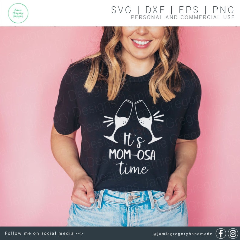 May include: A black t-shirt with a white graphic design featuring two champagne flutes clinking together and the text "It's Mom-osa Time".