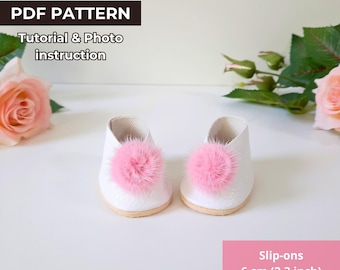 May include: White slip-on doll shoes with pink fur pom-poms. The shoes are 6 cm (2.3 inches) long and 5.5 cm (2.1 inches) wide. PDF pattern for doll shoes.