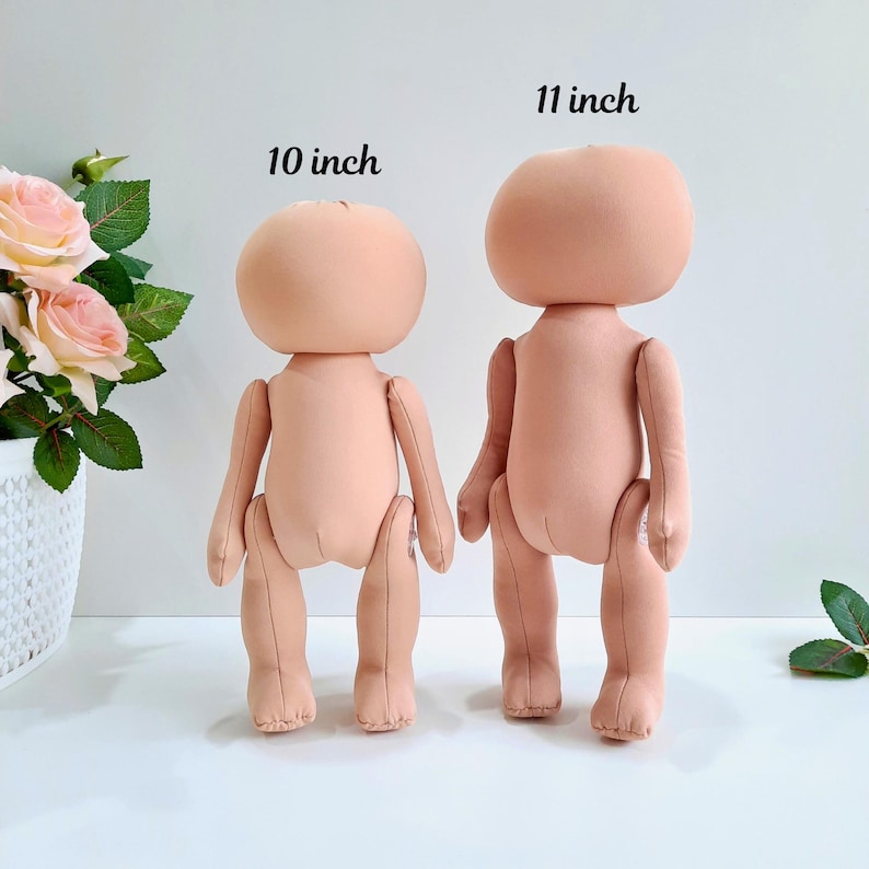 May include: Two unpainted doll bodies made of fabric, one is 10 inches tall and the other is 11 inches tall.