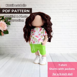 May include: A doll wearing a white t-shirt with a fruit pattern, green shorts, and white shoes. The doll has brown curly hair and a blank face. The image includes text that says "PDF PATTERN" and "Tutorial & Photo instruction". The shorts are designed for a 9-inch doll.