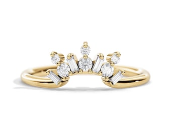 May include: A delicate gold band ring with a crown of small round and baguette diamonds.