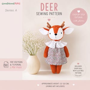May include: A sewing pattern for a plush deer doll, featuring text that reads DEER SEWING PATTERN, Series A, and GoodMoodTOYS. The doll has orange fur, white face details, brown antlers, and a floral dress with a white collar. Height is 13 inches.