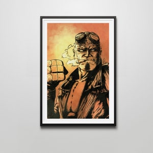 May include: Framed artwork featuring a comic book style illustration of a character with red skin, horns, and goggles, smoking a cigar. The character is wearing a black jacket and has a large, square-shaped right hand. The background is a gradient of orange and yellow.