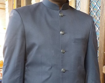May include: A dark gray suit jacket with a mandarin collar and six silver buttons. The jacket has a single pocket on the left chest and two flap pockets on the front.