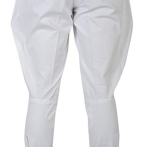 May include: White riding breeches with a button detail at the bottom of the legs.