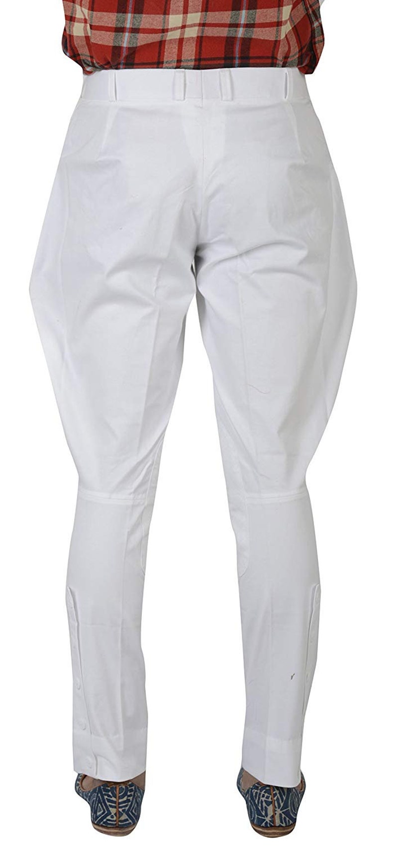 May include: White riding breeches with a button detail at the bottom of the legs.