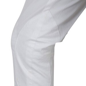 May include: White riding breeches with a reinforced knee patch.