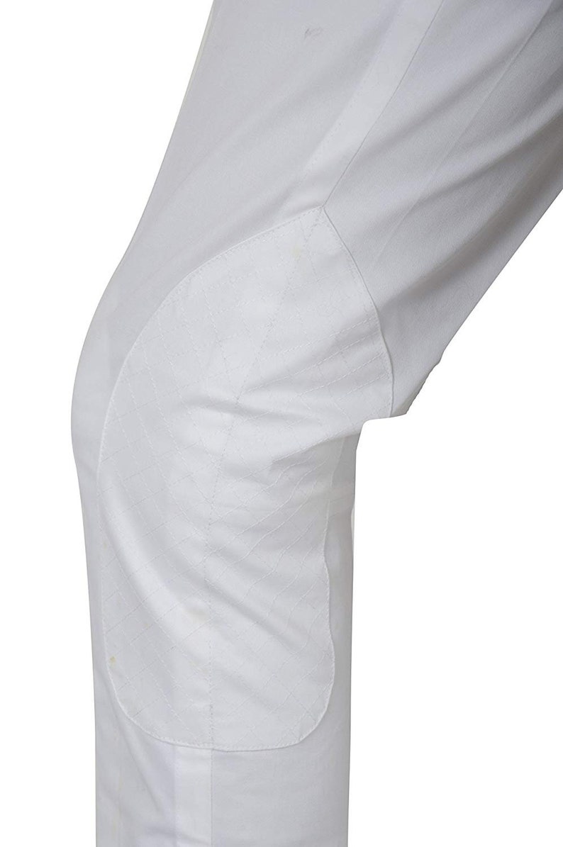 May include: White riding breeches with a reinforced knee patch.