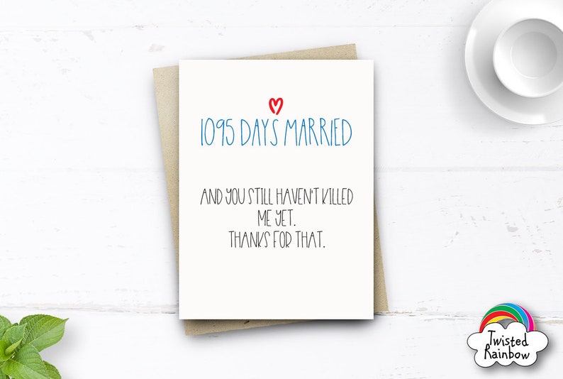 May include: A white card with a red heart and blue text that reads "1095 Days Married" and "And you still haven't killed me yet. Thanks for that."