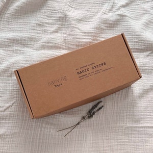 May include: A brown cardboard box with the text "Jialiving" and "MAGIC STICKS" printed on it. The box is labeled as an all-purpose cleaner and states that it is handmade in Los Angeles with 100% all-natural ingredients.