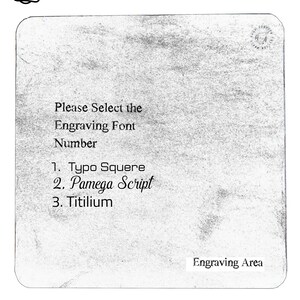 May include: A white card with black text that reads "Please Select the Engraving Font Number 1. Typo Squere 2. Pamega Script 3. Titilium" and "Engraving Area".