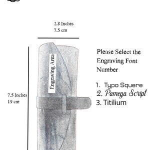 May include: A gray leather roll with a black strap. The roll is 7.5 inches tall and 2.8 inches wide. The text "Engraving Area" is written on the roll. The text "Please Select the Engraving Font Number" is written below the roll. The text "1. Typo Squere", "2. Pamega Script", and "3. Titilium" is written below the text "Please Select the Engraving Font Number".