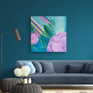 May include: A painting of pink peonies with green leaves against a background of colorful stripes. The painting is framed and hanging on a teal wall.