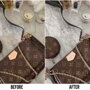 May include: A brown and gold Louis Vuitton handbag with a chain strap and a matching coin purse. The bag is on a white marble surface.