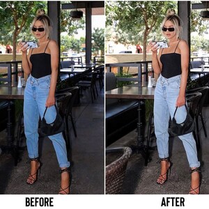 May include: A woman wearing a black tank top, light blue jeans, and black heeled sandals. She is holding a smartphone with a white case and has a black handbag.