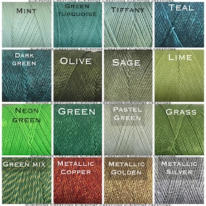 May include: A collection of 12 spools of yarn in various shades of green, including mint, turquoise, dark green, olive, sage, lime, neon green, pastel green, grass, green mix, metallic copper, metallic golden, and metallic silver.