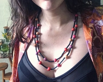 Adorable vintage wooden beaded double strand necklace with black, yellow, orange, pink, and violet beads