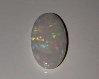 May include: A white oval opal gemstone with iridescent flashes of color.