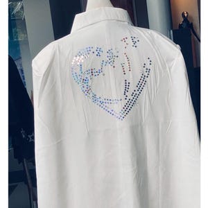 White cape with fabric buttons and a large multicoloured sequin double  heart  size large but fits sizes UK 10 to 14