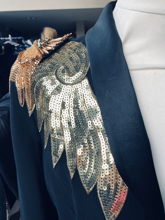 Black satin trim tuxedo with. gold sequin angel wings and removable gold chain spiky epaulettes no label but fits sizes 10 to 12