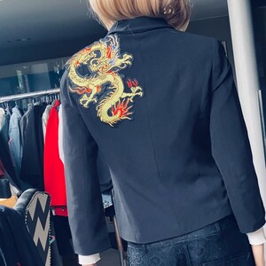 Black open Jacket with gold and red dragons on both shoulders on opposite sides size UK 10