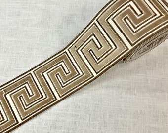 May include: Brown and white patterned trim with a geometric design. The trim is made of a soft, velvety fabric.