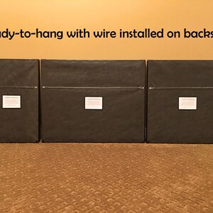 May include: Three framed prints with black frames and brown mats. The backs of the frames are visible, showing a wire hanger attached to each frame. The text "Ready-to-hang with wire installed on backsides" is visible at the top of the image.