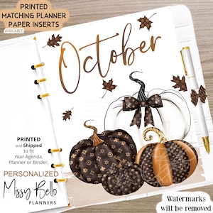 May include: A printable planner page featuring the word "October" in a brown script font with three pumpkins. The pumpkins are decorated with a brown and gold pattern. The page is designed for use in a planner or binder.