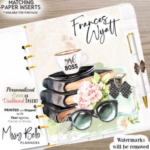 May include: A personalized planner cover featuring a watercolor illustration of a coffee cup with the text "girl boss", a stack of books, sunglasses, a flower, and a bottle of perfume. The text "Frances Wyatt" is written at the top of the cover.