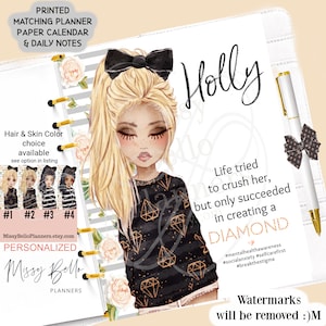 May include: A personalized planner with a black and gold diamond pattern and a cartoon illustration of a girl with blonde hair and black eyes. The planner cover has the text "Holly" and the quote "Life tried to crush her, but only succeeded in creating a DIAMOND".