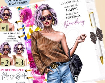 May include: A white planner with a floral design and a woman with purple hair wearing sunglasses and a brown sweater. The planner has the text "PRINTED MATCHING PLANNER PAPER CALENDAR & DAILY NOTES" at the top and "PERSONALIZED Missy Bello PLANNERS" at the bottom. The text "UNBOTHERED. moisturized. HAPPY. In my lane. FOCUSED. flourishing." is on the right side of the planner.
