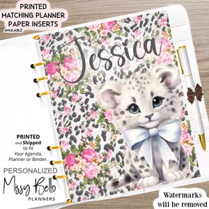 May include: A white planner cover with a pink and gray leopard print background. A white kitten with black spots and a white bow is in the center of the cover. The name "Jessica" is written in black cursive above the kitten. The text "PRINTED and Shipped to fit Your Agenda, Planner or Binder. PERSONALIZED Missy Bello PLANNERS" is in the bottom left corner. The text "Watermarks will be removed" is in the bottom right corner.