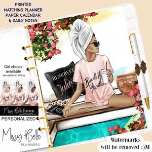 May include: A personalized planner with a woman in sunglasses and a towel on her head, holding a drink. The planner includes a matching paper calendar and daily notes. The text on the shirt says "Beverly Hills Vacation". The planner has gold rings and a pen with a bow.