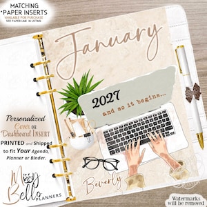 May include: A planner dashboard insert featuring the text January, 2027 and so it begins, and Beverly. The design includes a potted succulent, a laptop with hands typing, and black-rimmed glasses on a beige background with gold ring binding.