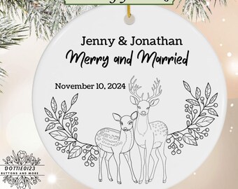 May include: A white ceramic Christmas ornament with a deer design. The ornament features the names "Jenny & Jonathan" and the phrase "Merry and Married" with the date "November 10, 2024". Includes a "Free Gift Box" label.