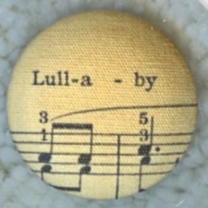 Lilac Bow Yoke Fabric Covered Button of a piece of Musical Lullaby Sheet music  from the 1990s - LY24, buttons, button gift, button