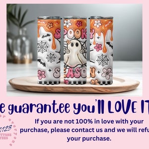 May include: Three white tumblers with a black and white spooky season design. The tumblers have orange dripping paint and a ghost with the words "Spooky Season" on them.