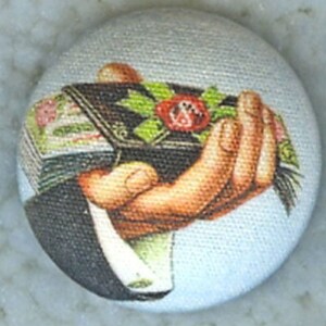 May include: A hand holding a bouquet of flowers with a red rose in the center. The bouquet is wrapped in a black and white patterned paper.