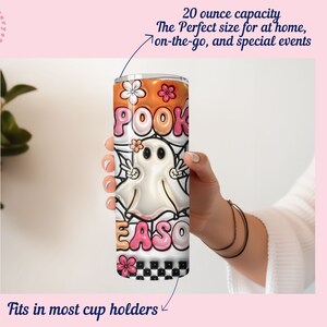 May include: A white ghost with black eyes and a pink mouth on a 20 ounce tumbler. The tumbler has a black and white checkered pattern at the bottom and a pink, orange, and white design with the words "POOK EASO" on the rest of the tumbler.