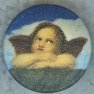 May include: A vintage button featuring a painting of a cherub with brown wings against a blue and white cloudy sky.