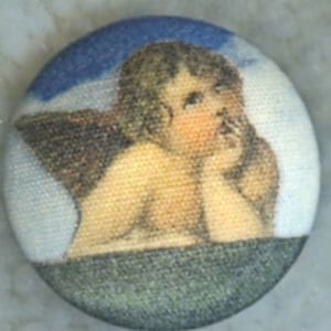 May include: A round button with a blue and white background featuring a cherub with wings. The cherub is depicted with a thoughtful expression, looking down and holding a finger to its lips.