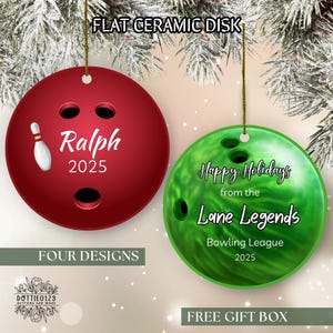 May include: Two flat ceramic disk ornaments. One is red with the name "Ralph" and the year "2025". The other is green and reads "Happy Holidays from the Lane Legends Bowling League 2025".