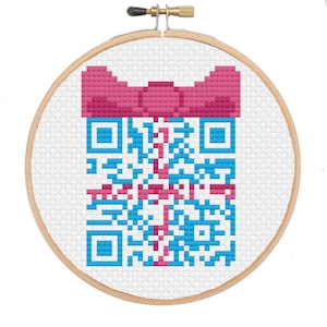 May include: A blue and pink QR code with a pink bow on top, embroidered on white fabric in a wooden embroidery hoop.