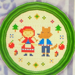May include: A framed cross-stitch embroidery depicting a red-hooded girl and a wolf in a forest setting. The embroidery features a white background with red, blue, and green accents.
